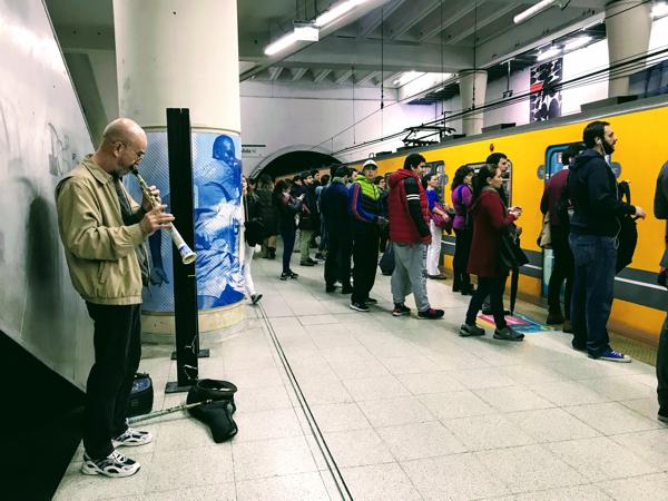 The man was playing oblivious to the crowd during rush hour. I have a few seconds to capture this moment. Where was I going?