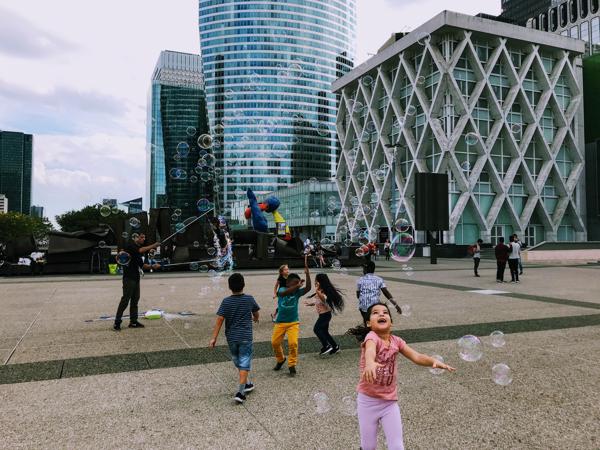 Back home, walking across the dystopian esplanade of La Defénse. The kids were having so much fun.