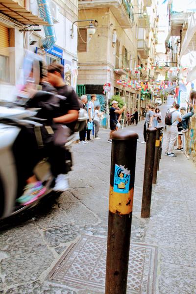 In the cuore of Naples, if Maradona place of idolatry is at the heart of the city. Capturing a sticker with Maradona's face, a very italian scoorter passed by.