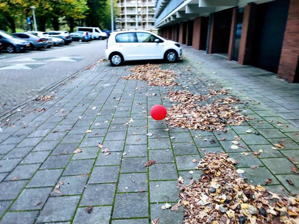 Riding back from the supermarket to our A&B, north of Amsterdam, this red balloon was whirling around in the parking place.